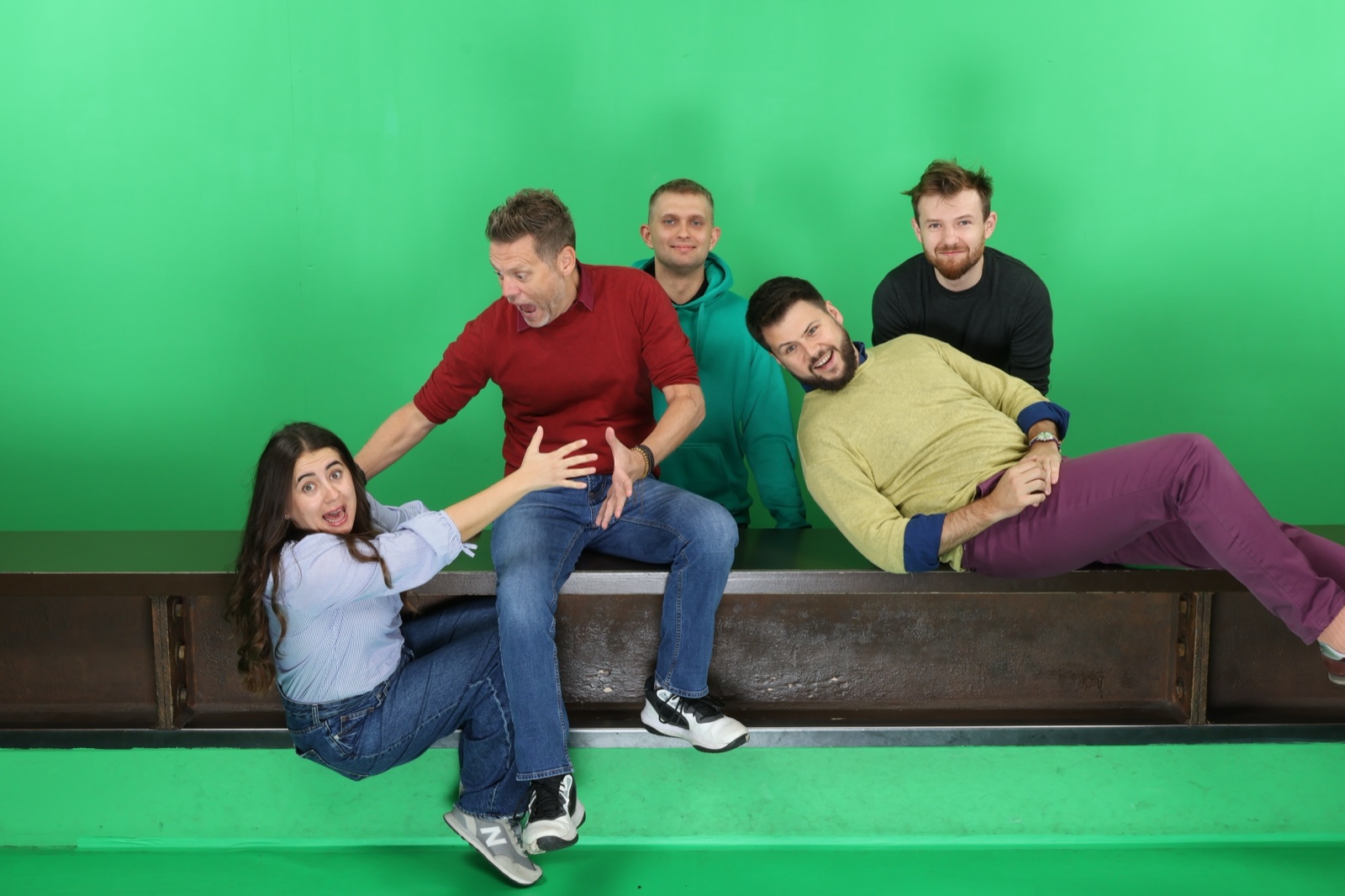 The same group on the steel beam in front of the green screen, before the background is swapped in