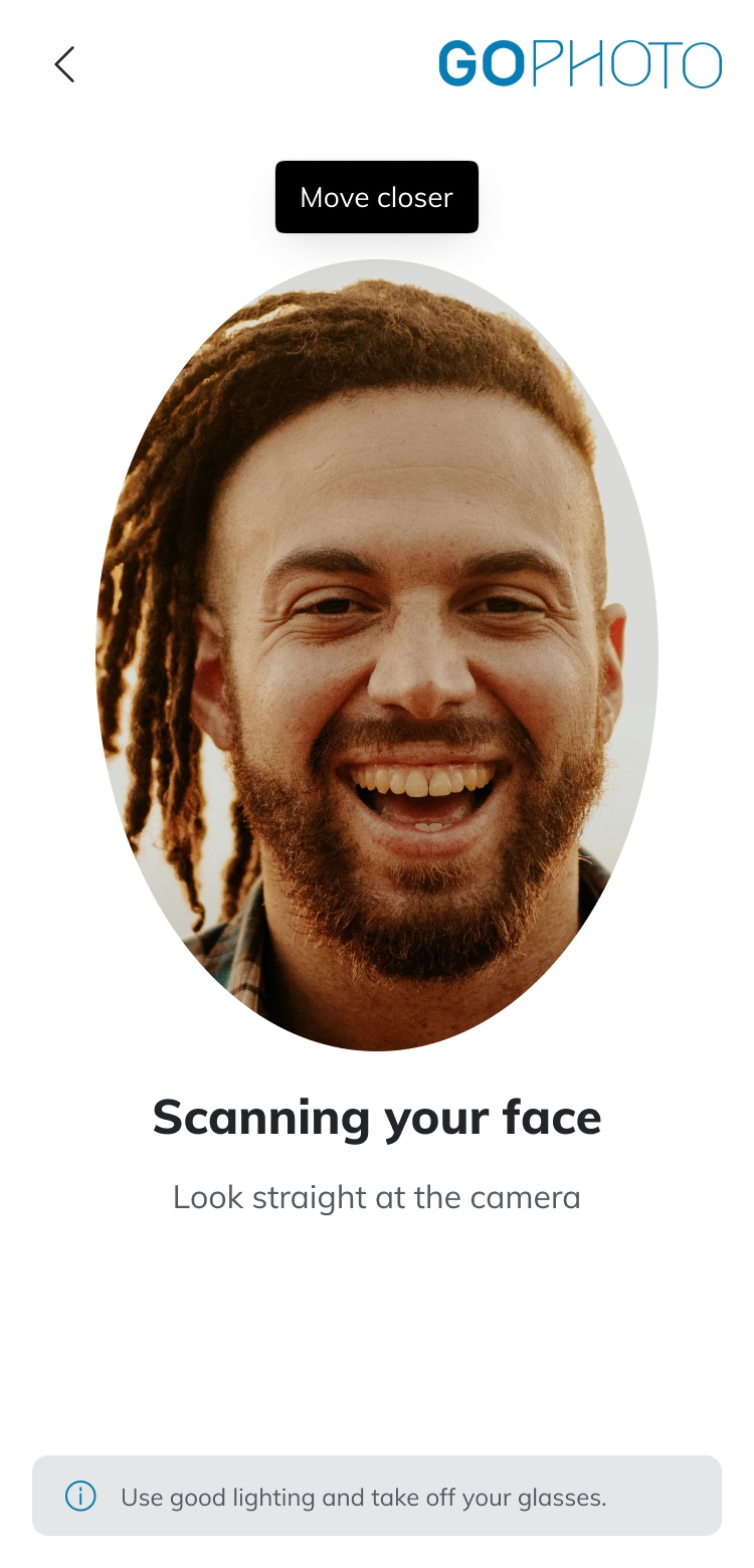 Scanning your face: a live camera view inside an oval mask with a &ldquo;Move closer&rdquo; prompt and a lighting hint